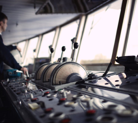 Navigation officer driving the ship on the river.